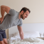 Man waking up in the morning and suffer for back pain